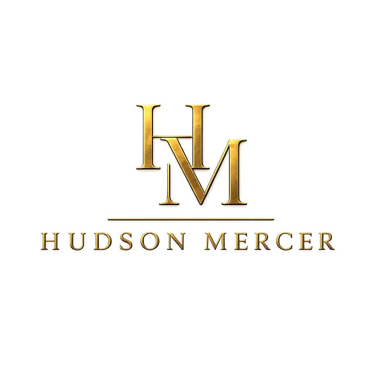 The Hudson Mercer monogram plate — an interlocked gold H and M above the wordmark